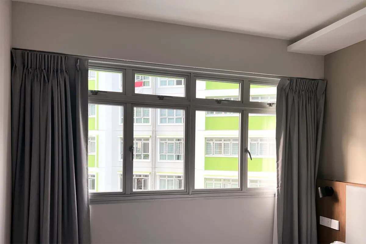 Full-height curtains installed beside HDB windows