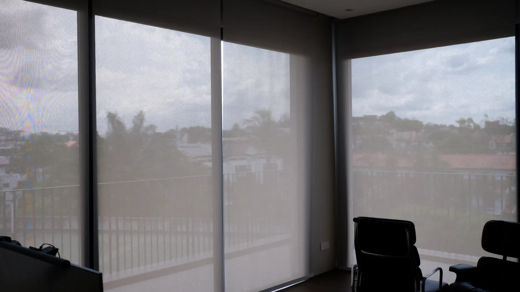 Screen roller blinds filtering daylight across wide windows
