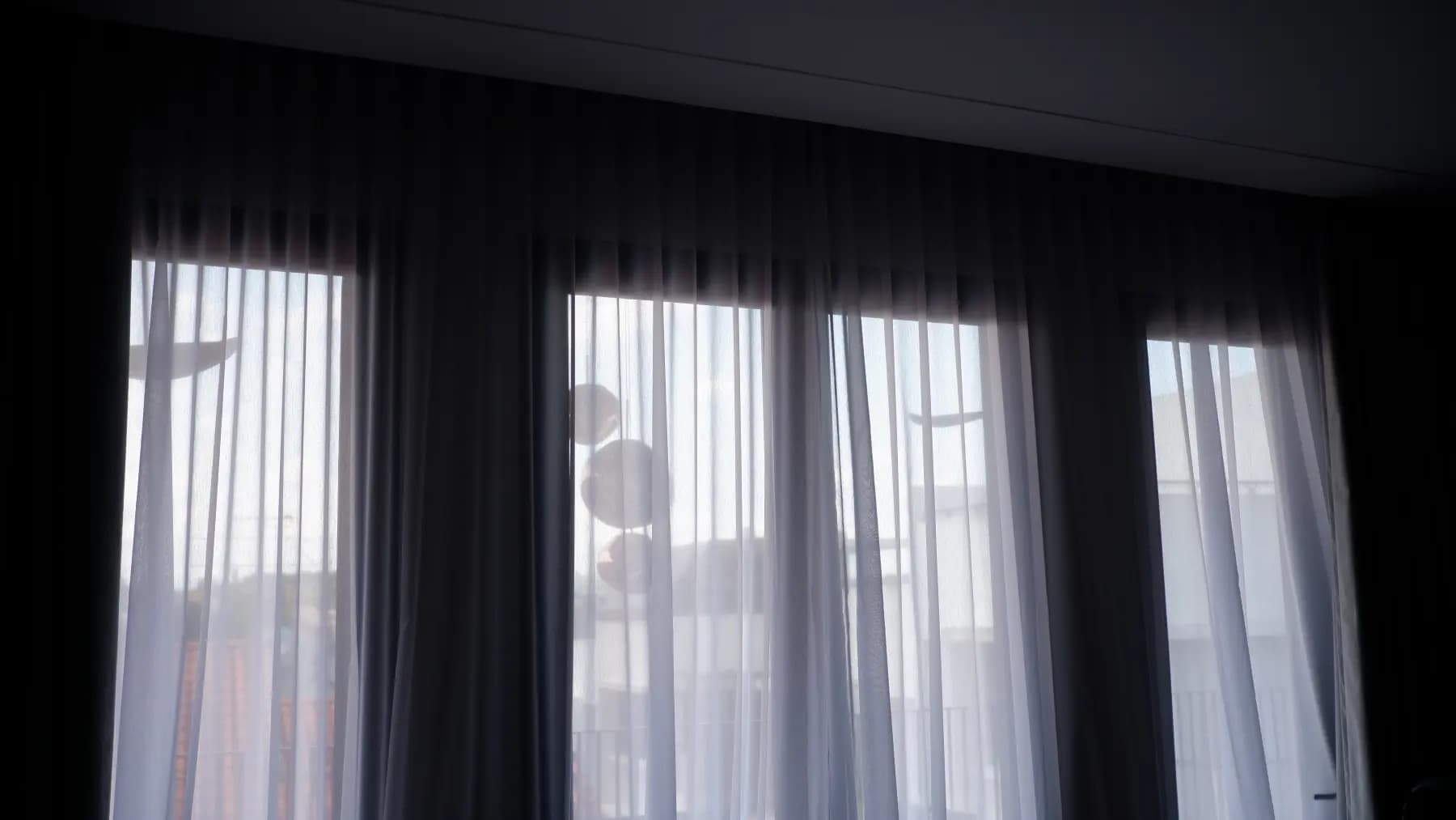 Sheer day curtain layered beside a night curtain